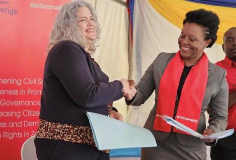 Swedish Embassy in Lusaka Acting Ambassador Sussana Hughes and ActionAid Country Director Faides TembaTemba During a grant signing ceremony in Lusaka 