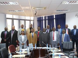 ActionAid staff posing with Members of Parliament
